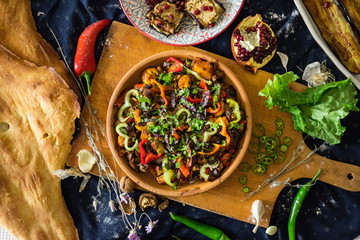 Ajapsandal vegetables stew in clay ketsi dish. Traditional Georgian food made cooked with different...