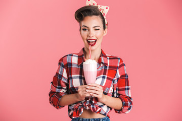 Portrait of a cheerful brunette pin-up girl in plaid