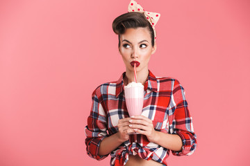 Portrait of a cheerful brunette pin-up girl in plaid shirt