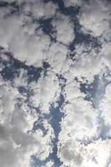 Summer sky with puffy dark clouds