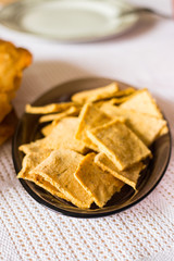 Yellow corn flour flat breads chips with herbs, spices. Vegan vegetarian healthy food.