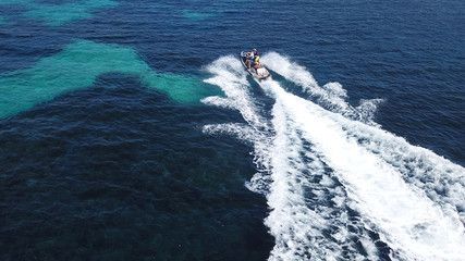 Top view of jet ski cruising in deep blue sea