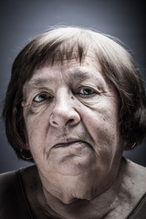Studio portrait of elderly woman. Sad. Toned