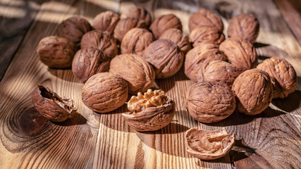 Walnuts on a wooden table. Natural sunlight from the window