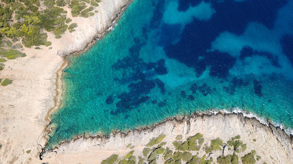 Aerial photo of tropical rocky seascape with beutiful turquoise clear sea and boats docked