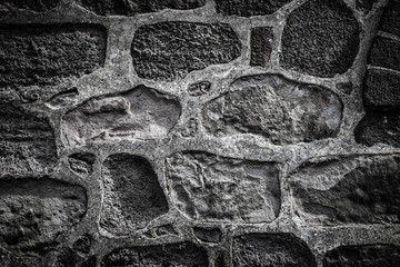 Wall built of natural stone. Toned
