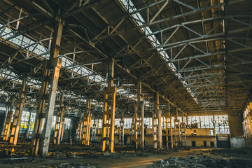 Abandoned ruins of industrial factory building inside, corridor view, perspective and sunlight, creepy ruins and demolition concept