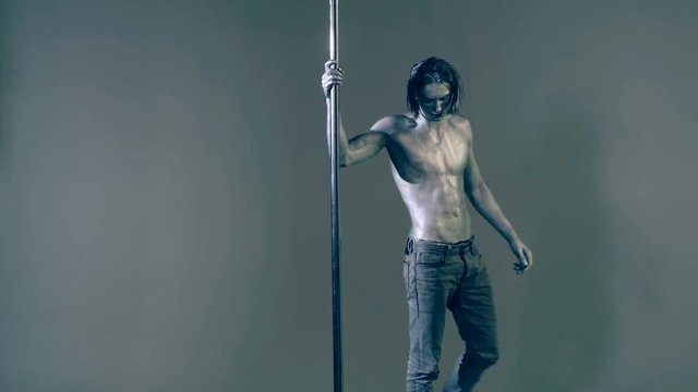 Flexibility of pylon man dancer. Fashion man pilon dancer. Concept pilon dancer.