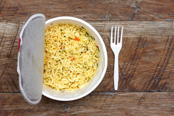 instant noodles on wooden background, top view close-up