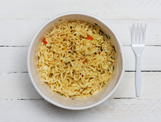 instant noodles on wooden background, top view close-up