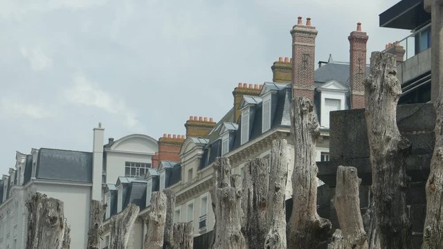 View of the old wooden breakwaters on the beach of the Atlantic Ocean  against the background of the houses and sky, Saint- Malo, France