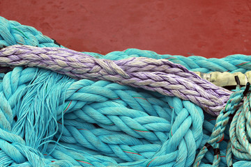 purple and blue green moring lines against red hull of ship, Bermuda