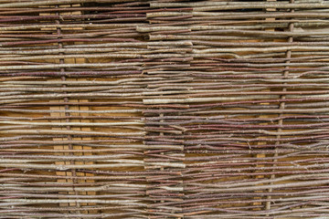Wicker fence made of natural branches, beackground, texture