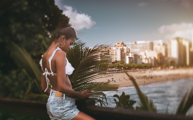 Rear tilt-shift view with selective focus of an African-American girl on a high point of an...