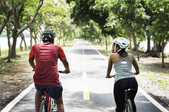 Cyclist couple riding bikes in a park