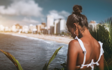Rear tilt-shift view with selective focus of an African-American girl on a high point of an...
