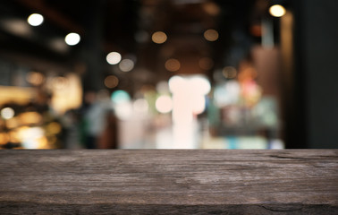 Empty dark wooden table in front of abstract blurred bokeh background of restaurant . can be used for display or montage your products.Mock up for space.