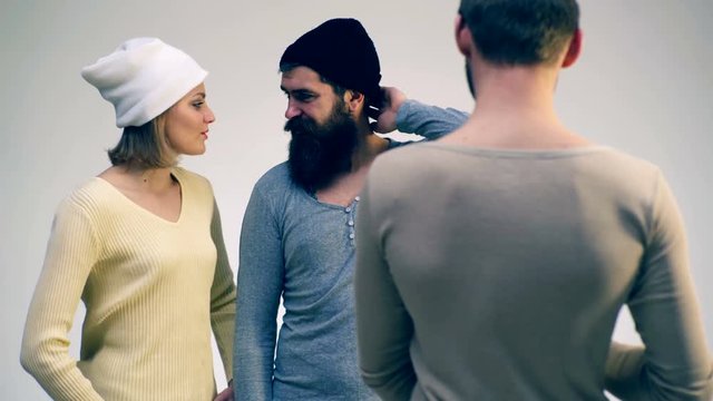 Boy and girl wearing hats are talking to a friend. Communicate a group of people.