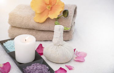 Obraz na płótnie Canvas Spa accessories aromatic candle,compress ball, salt scrub and towel.