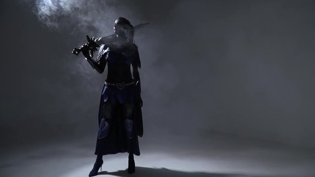 A dark elf woman with an epic sword posing in the dark among smoke