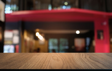 Empty dark wooden table in front of abstract blurred bokeh background of restaurant . can be used for display or montage your products.Mock up for space.