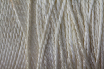 Cut piece of rough texture twine string. white string. Skein of jute rope with loose end on white 