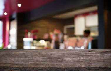 Empty dark wooden table in front of abstract blurred bokeh background of restaurant . can be used for display or montage your products.Mock up for space.
