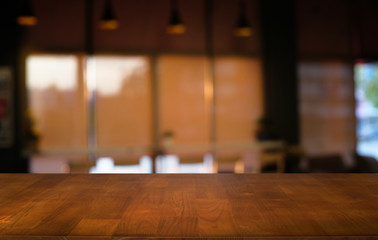 Empty dark wooden table in front of abstract blurred bokeh background of restaurant . can be used for display or montage your products.Mock up for space.