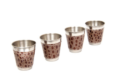 Metal flask trimmed leather and metallic sturdy shot glasses on a white background