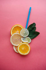 Conceptual photography. Citrus lemonade or fresh fruit juice. Mix of orange, lemon, lime and mint