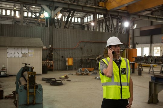 Marine engineer talking on mobile phone