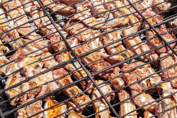 Grilled pork ribs on the grill. Barbecue in the nature at summer.