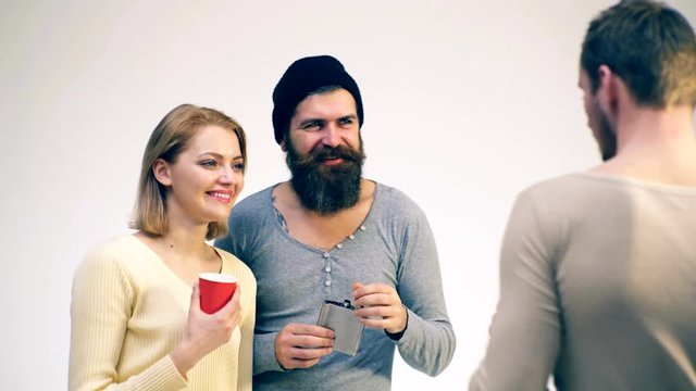 Group of people is talking and drinking alcohol. Cheerful meeting of old friends. Concept of the party.