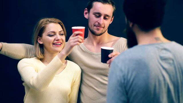 Boy and girl are drunk with an old friend. Meeting old friends. Concept of the party.