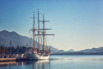 Fototapeta na wymiar Night Embankment in Tivat, view of an old sailing ship. Montenegro