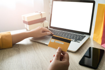 Woman and Small shopping cart with Laptop for Internet online shopping concept.