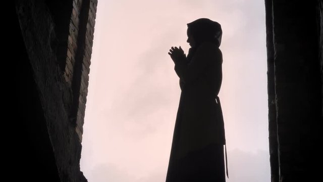 Young refugee muslim woman in hijab standing in abandoned building, frightened and terrified