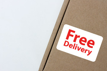 free delivery, business,online shopping, ecommerce and delivery service concept - brown box with note " free delivery "