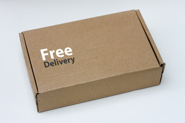 free delivery, business,online shopping, ecommerce and delivery service concept - brown box with note 