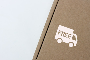 free delivery, business,online shopping, ecommerce and delivery service concept - brown box with note " free delivery " on a gray background.
