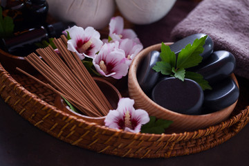 spa setting with hibiscus flowers on brown