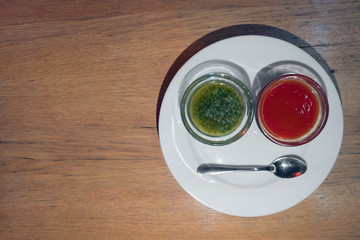 top view of plate with green and red sauce;