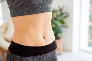 Body part wellness wellbeing eating nutrition lifestyle concept. Close up cropped photo of fit slim slender sportive skinny with pecs and ideal flawless perfect skin woman's belly - obrazy, fototapety, plakaty