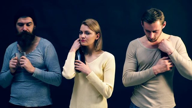 Young people hide bottles of alcohol from each other. Concept of alcoholism.