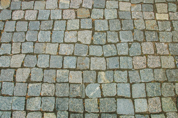 Abstract background of old cobblestone pavement view from above