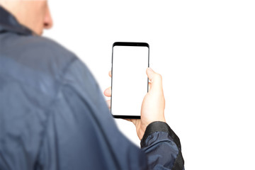 Man holding a smartphone with an isolated white display in right hand. Suitable for product mockup. Front view position with white background