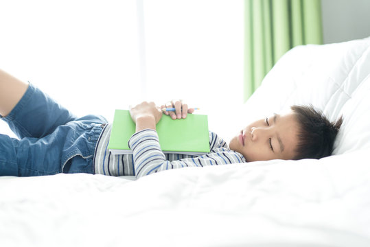 Boy sleeping with homework