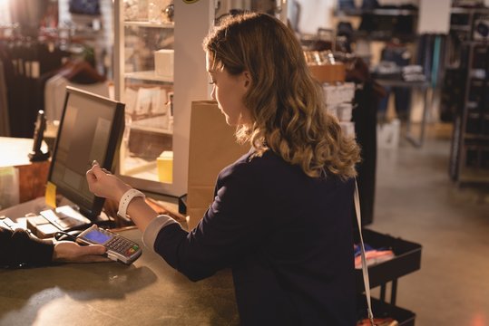 Woman making payment through smartwatch
