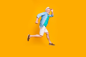 Naklejka na ściany i meble Happiness emotion facial expressing hold hand empty place concept. Turned full length size view photo portrait of cheerful excited lovely cute handsome gentleman jumping up isolated vivid background