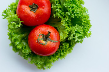 Fresh red tomatoes and green salad